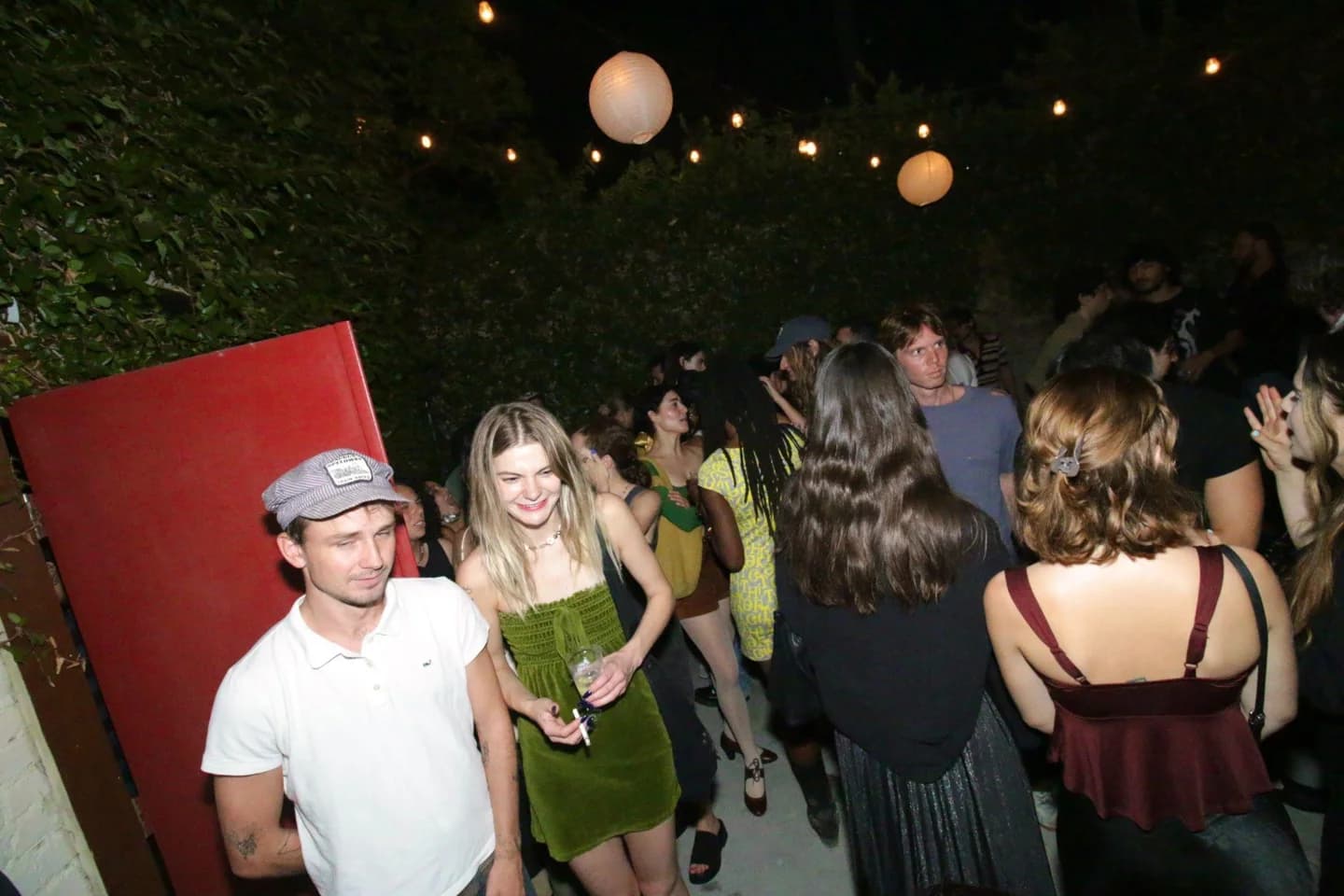 Guests gathering in a courtyard at night