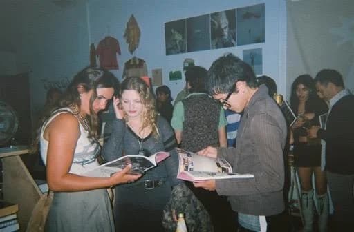 Guests looking through a magazine together