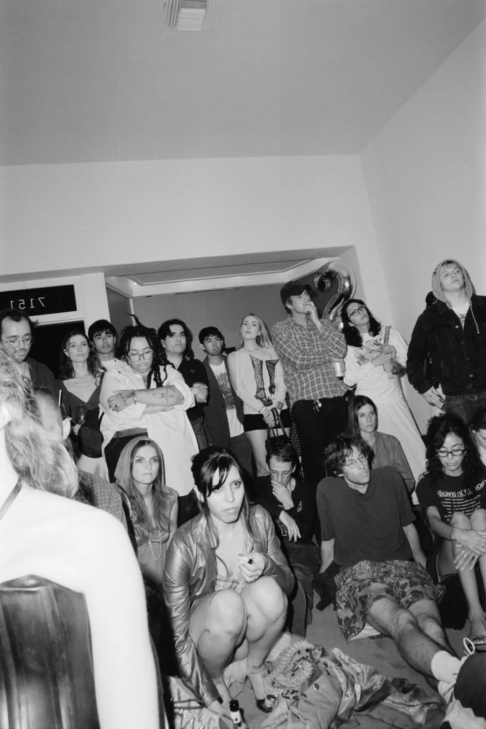 A group posing together indoors, in black and white
