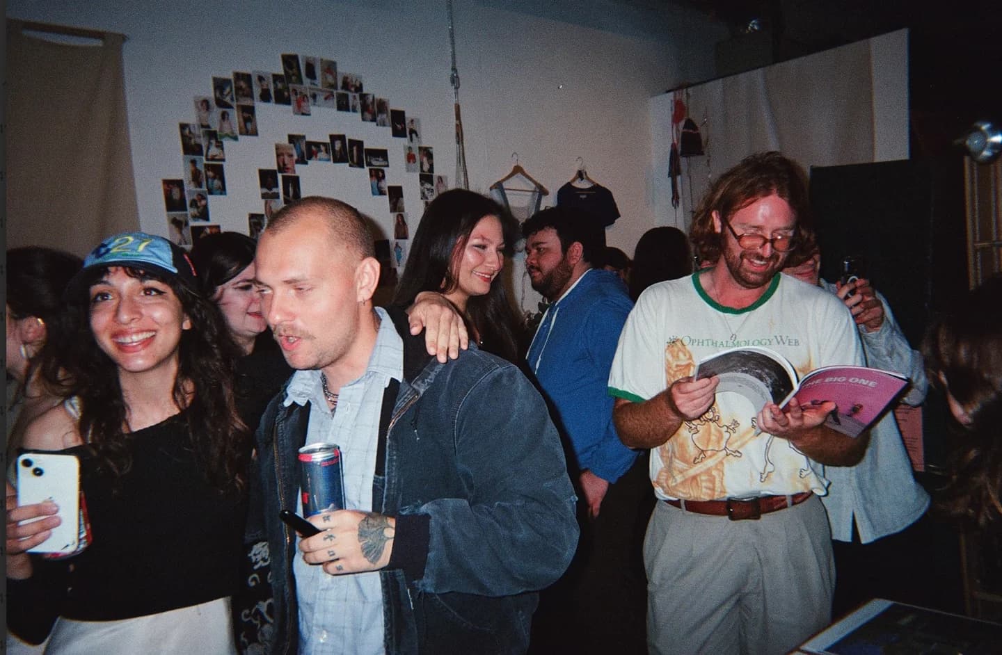 Guests mingling while a reader browses The Big One