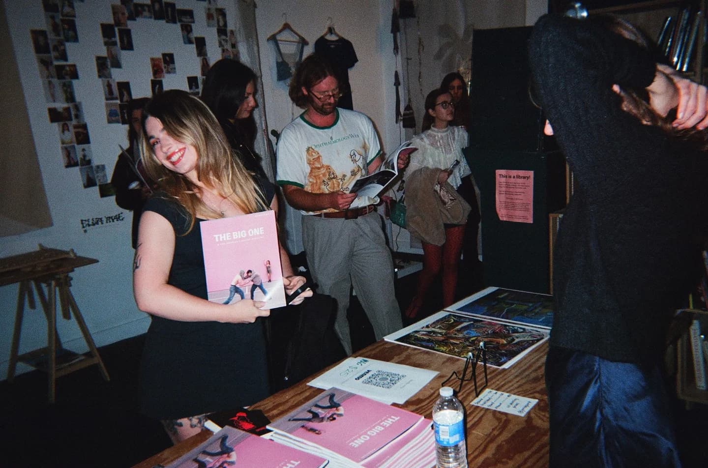 A guest holding The Big One beside the magazine table
