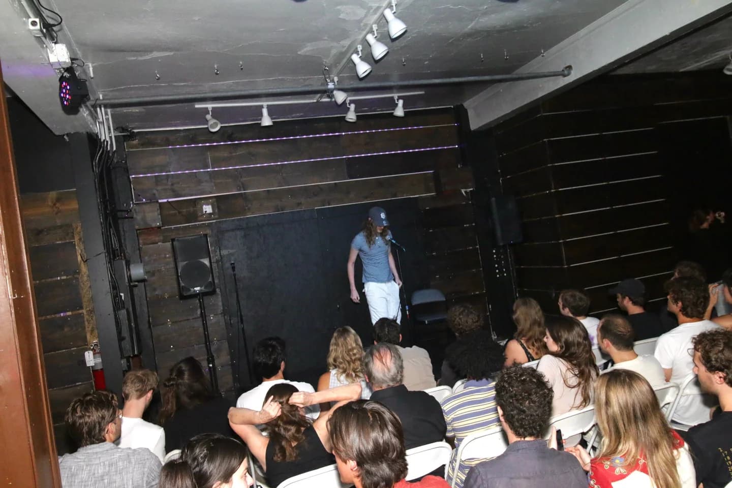 A speaker at a microphone facing a seated audience