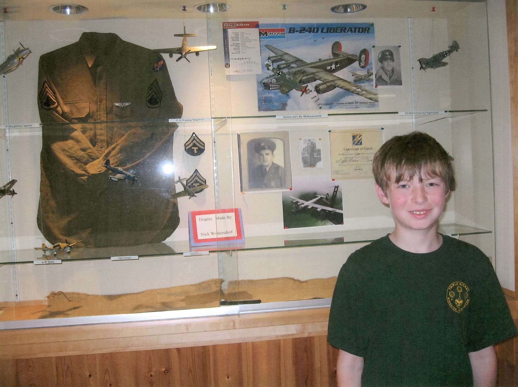 The author circa January 2006 with a display of WWII-era American, Russian, British, German and Japanese aircraft and Woltersdorf family military aviation heirlooms. Model kits from various manufacturers, in various scales. Displayed at Kitsap Regional Library, Poulsbo, Washington, from January to June 2006.