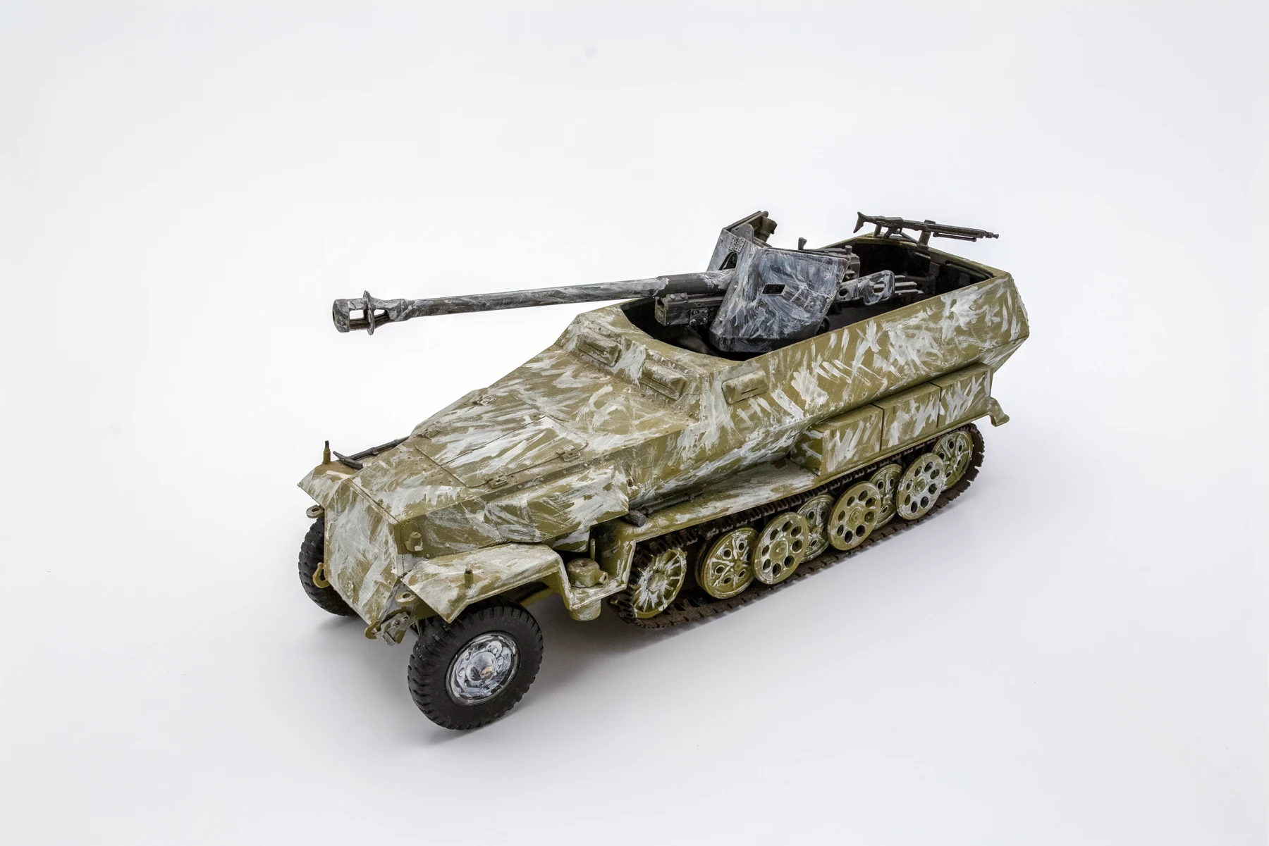 Scratch-built combination of Tamiya Sd.Kfz. 251 “Hanomag” and Tamiya 75mm Pak 40 Anti-Tank Cannon kits, 1/35 scale. Wehrmacht vehicle at the Ardennes Offensive, December 1944. Photo by Nicholas Woltersdorf.
